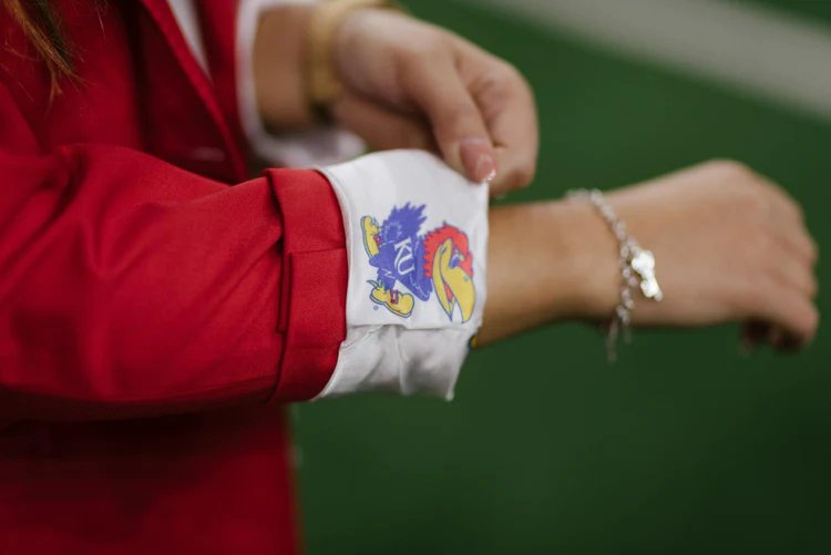 A close up photo of the sleeve of a red blazer.