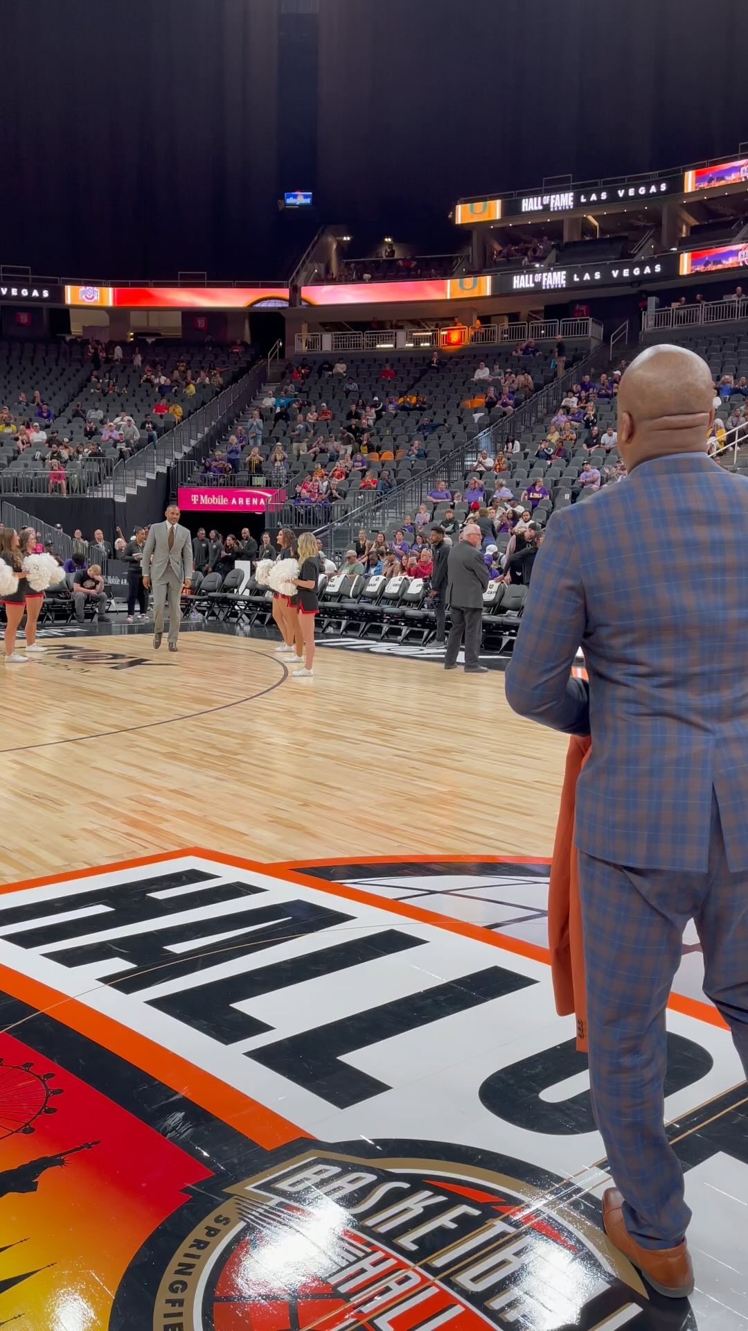 Carlton in Basketball Hall of Fame handing a Reveal Blazer to a player.