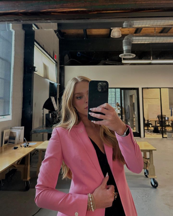 Woman wearing a pink Reveal blazer.