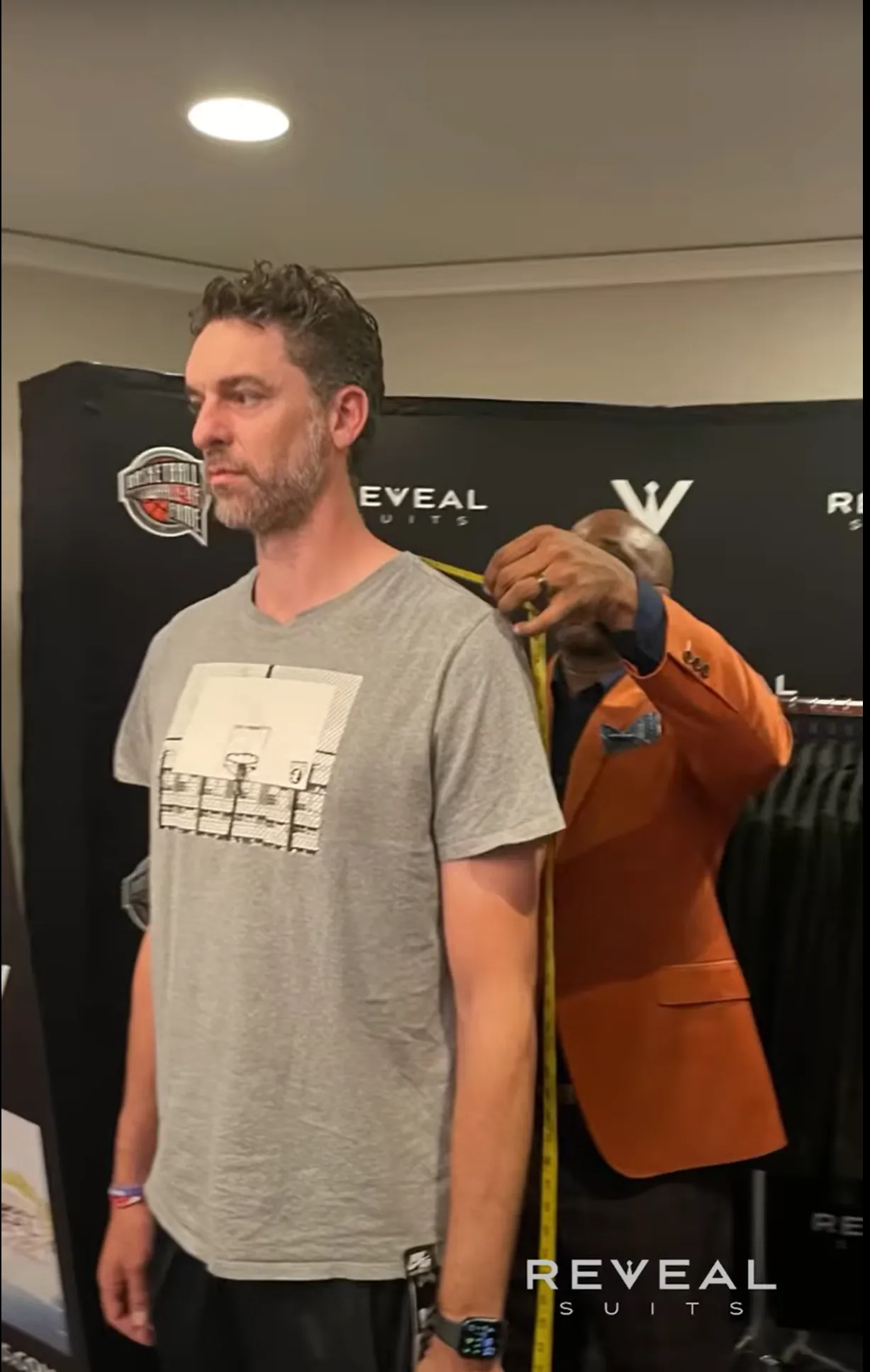 Carlton taking measurements of an athlete.